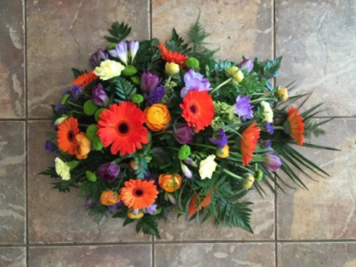 Orange Single Ended Spray - Traditional single ended spray in oasis made in orange and purple toned flowers. At Hearts and Flowers we are delighted to present this product available for flower delivery in Cardiff and surrounding areas and surrounding areas.