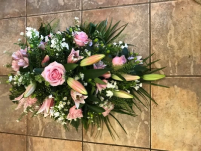 Pink Single Ended Spray - Single ended spray in oasis made in pink shades to include lillies and roses. At Hearts and Flowers we are delighted to present this product available for flower delivery in Cardiff and surrounding areas and surrounding areas.